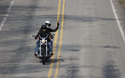 This is what it means when a motorcyclist points up towards the sky