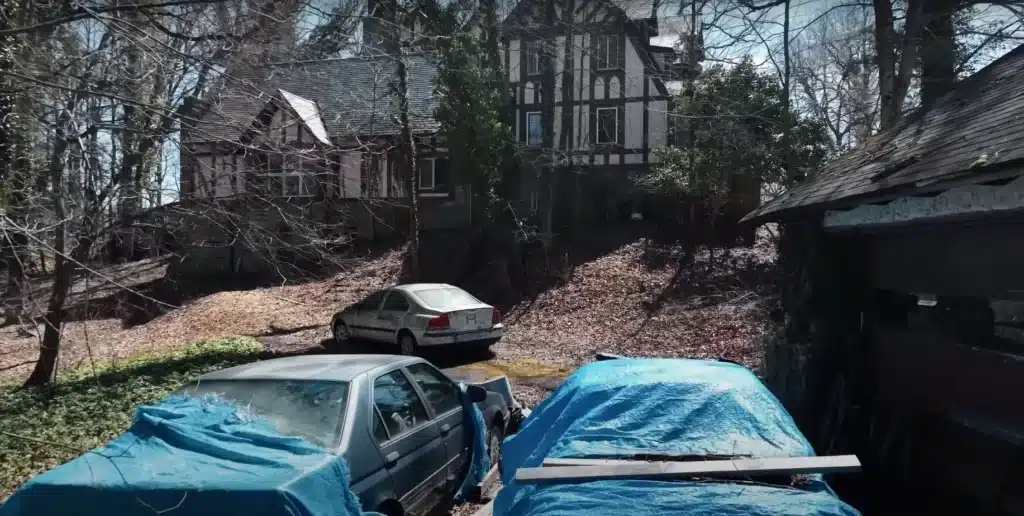 Man explores abandoned mansion in small American town where owner left luxury car collection to rot