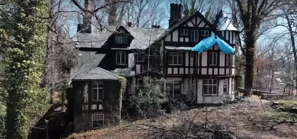 Man explores abandoned mansion in small American town where owner left luxury car collection to rot
